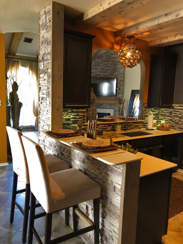 Kitchen bar design using stacked stone panels on the exterior surface.