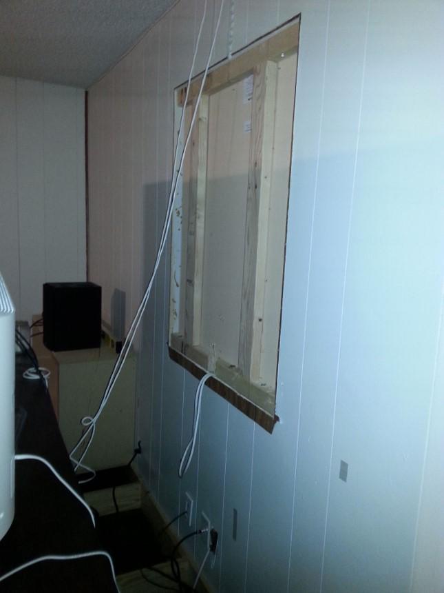 Preparing the space: a wooden panel secured with torx head screws covered the window.