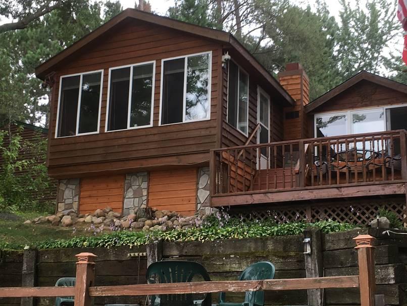 Fieldstone panels accent the exterior of a lakeside home.