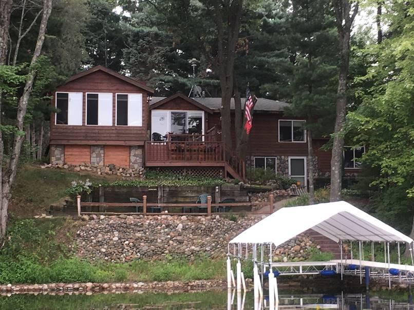 Lake house redesigned with new Fieldstone style siding to accent the existing wood.