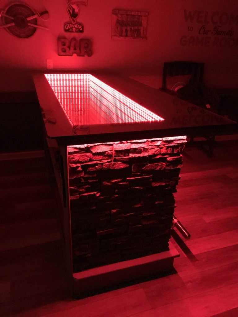 Infinity bar with red LED lights and stacked stone finish.