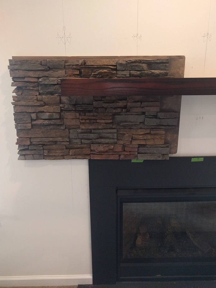 Fitting the cut panel around the mantel.
