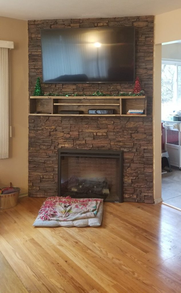 Stone look fireplace created with Norwich Colorado Stacked Stone panels attached to a plywood backing.