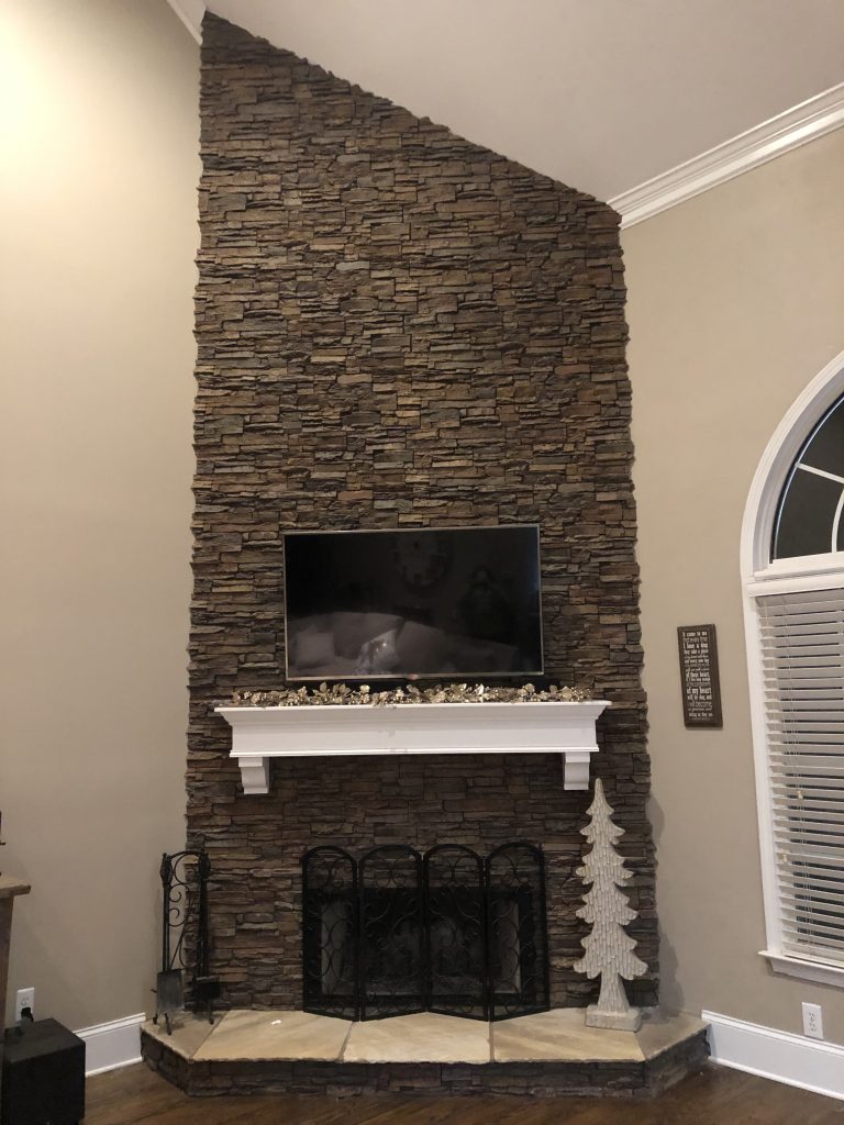 Brick fireplace replaced with Norwich Stacked Stone panels.