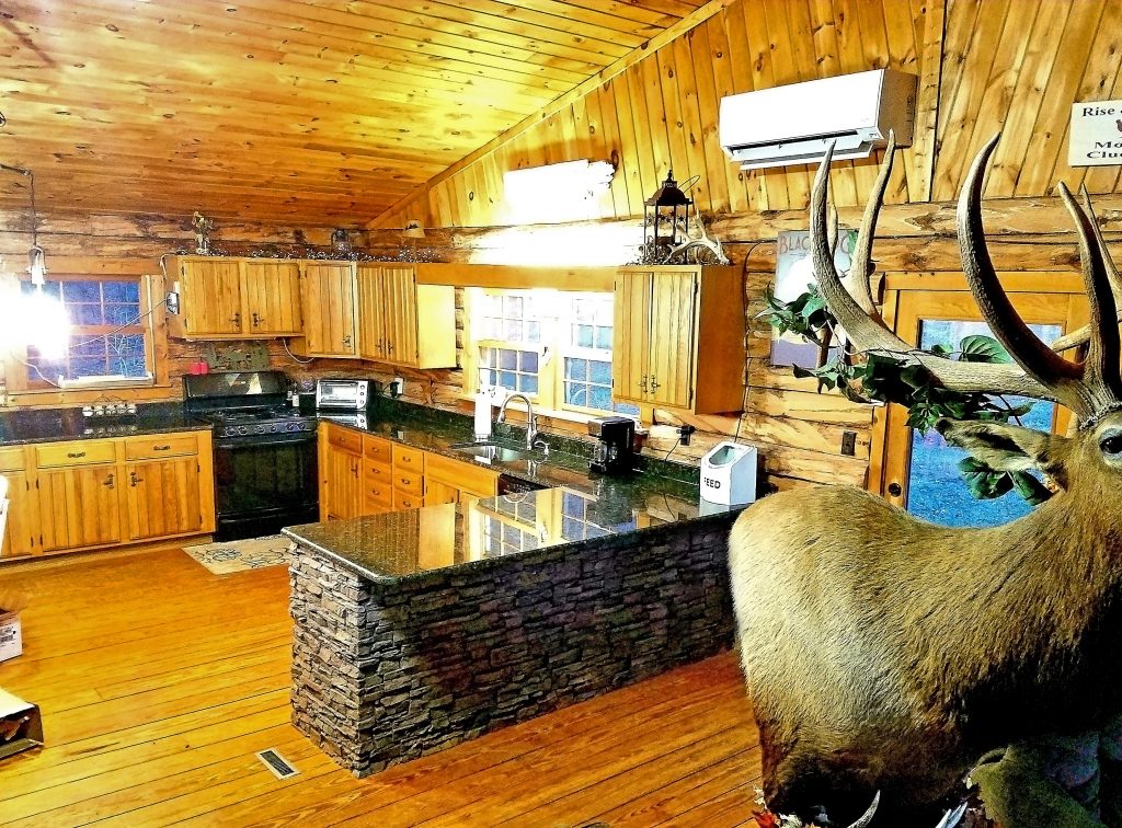 Lodge style home's kitchen remodeled with a beautifully rustic kitchen island resurfaced with stacked stone style panels.