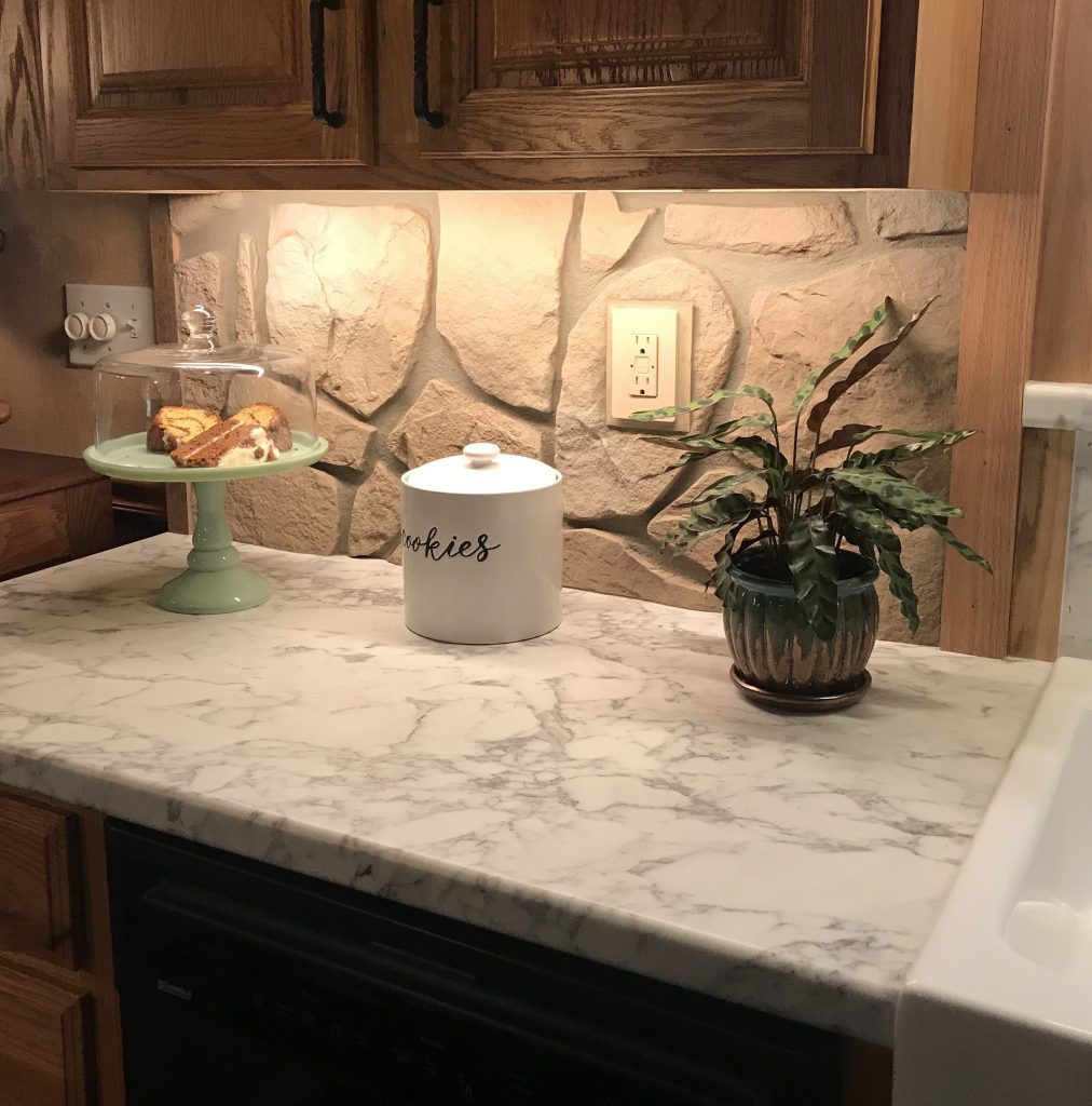 Kitchen backsplash made with easy-to-cut panels to accommodate electrical outlets and switches.