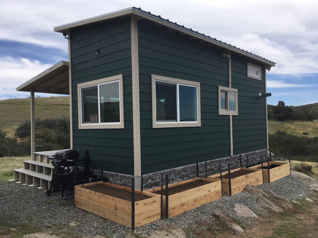 A tiny house's faux foundation created with Novi Fieldstone siding in Rocky Mountains color.