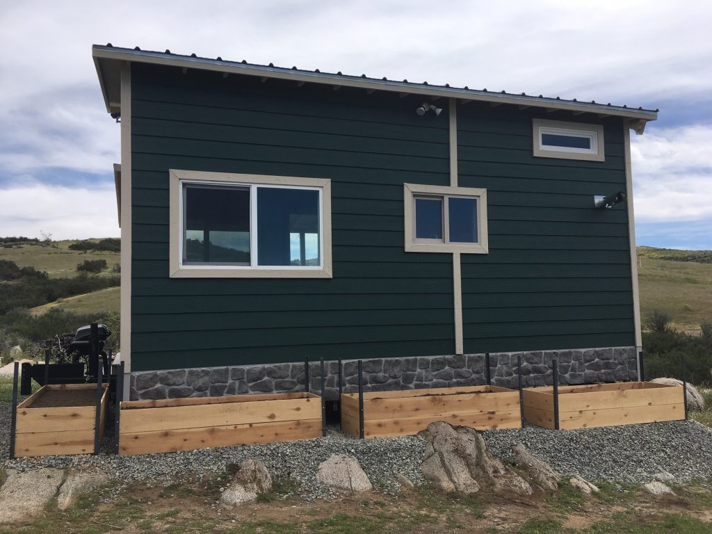 Tiny house skirting made with Novi Fieldstone siding to create the appearance of a hand-laid stone foundation.