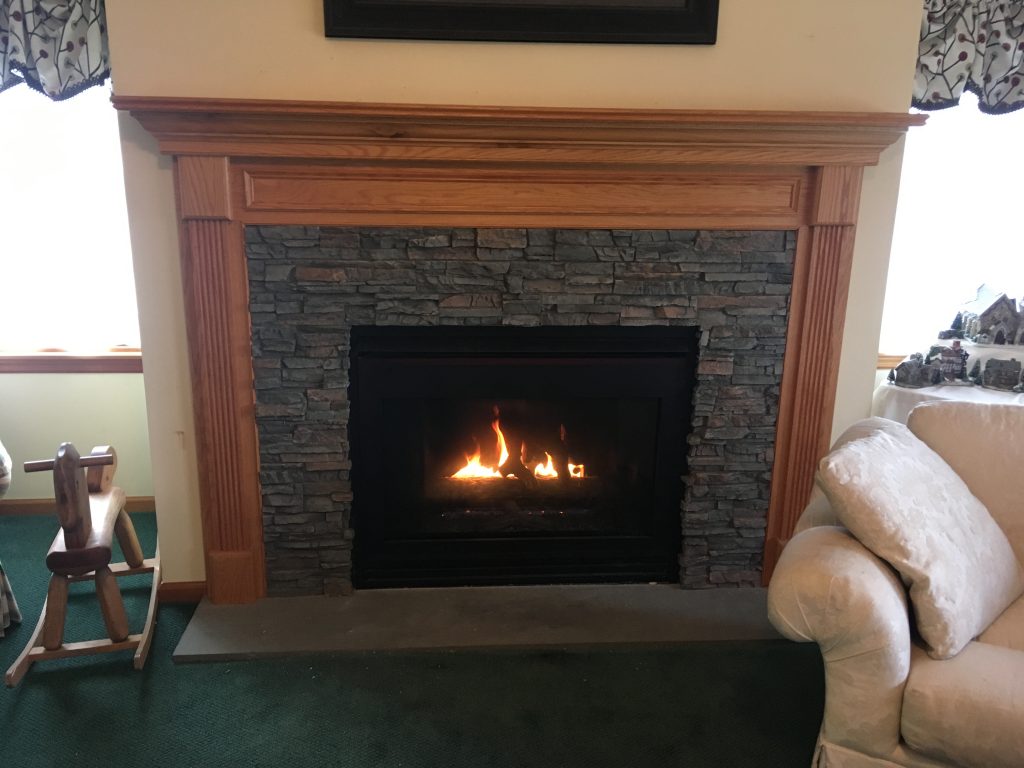 Fireplace surround refinished with Regency Stacked Stone panels in Potomac color.