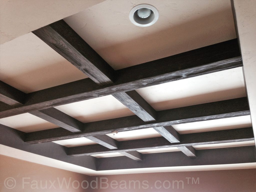 Faux wood beams arranged in a grid pattern on a tray ceiling.