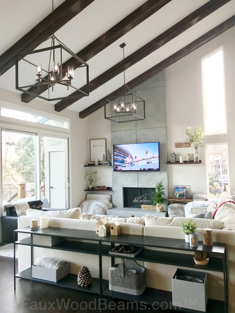 Modern living room with rustic accent beams on the high vaulted ceiling.