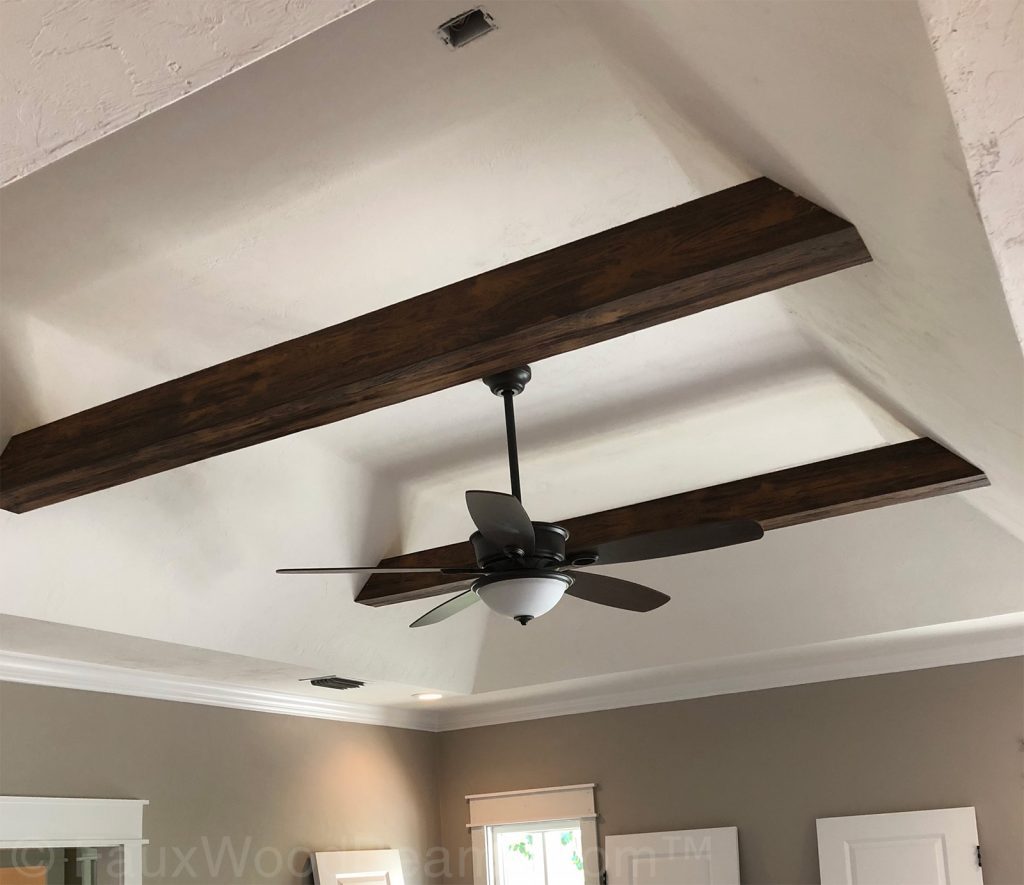 Suspended beams installed across a tray ceiling.