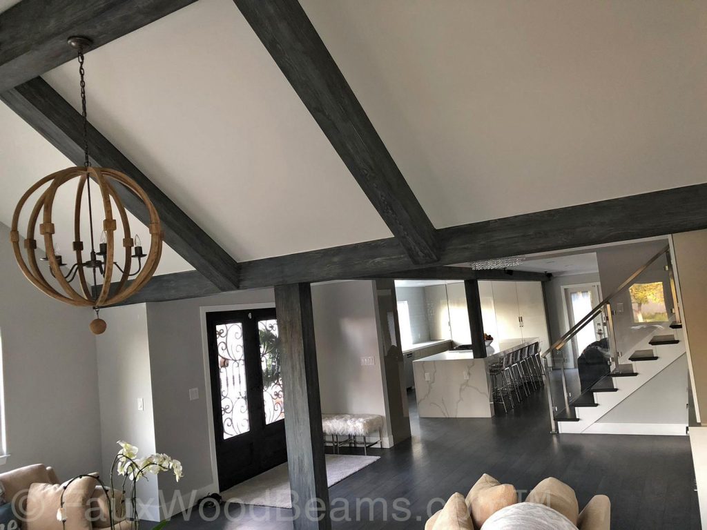Custom Driftwood Beams provide a striking framework for an open plan kitchen and living room.