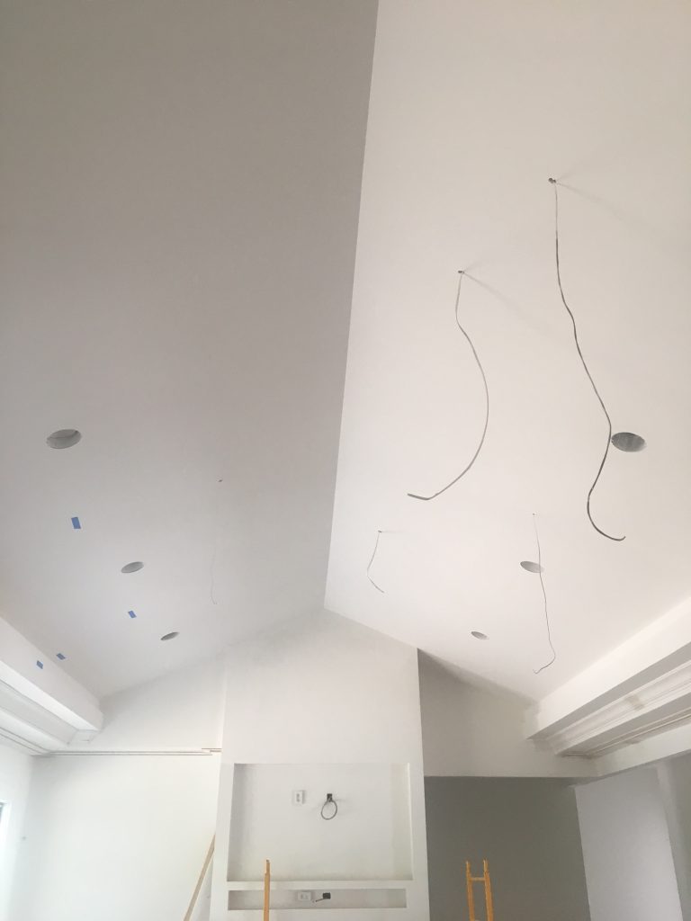 As you can see from this BEFORE picture, the power cables for the lights actually run through the ceiling drywall. Holes were then cut to mount the chandeliers securely.