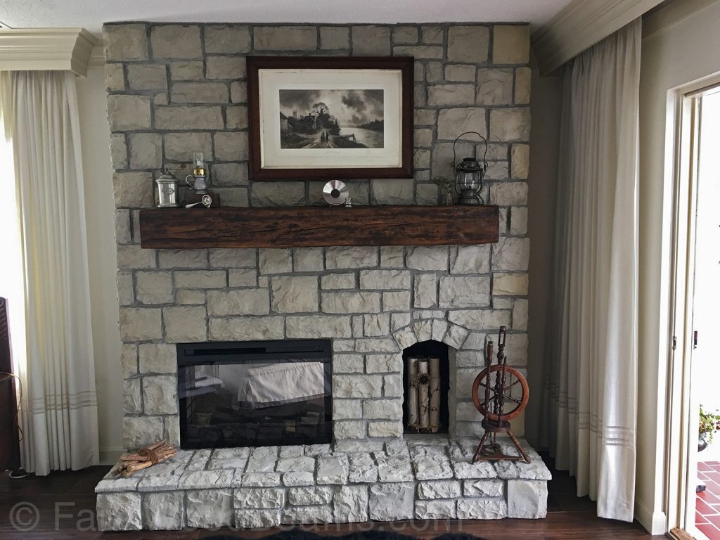 Large rock fireplace with a Custom Timber mantel.