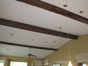 Rubber mounting straps cover the join between two fake wood timber beams.