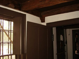 Faux wood beams and faux wood corbels blending seamlessly with the existing, historic wood