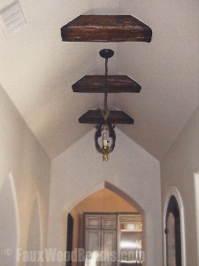 Synthetic wood beams cut short and installed to look like structural supports.