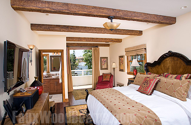 Horizontal ceiling beams traditionally span the shortest gap between walls, like in this bedroom.