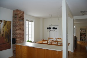  BEFORE: Drab white counter space and a bare ceiling made this a practical, but unexciting use of the dining arrangement.