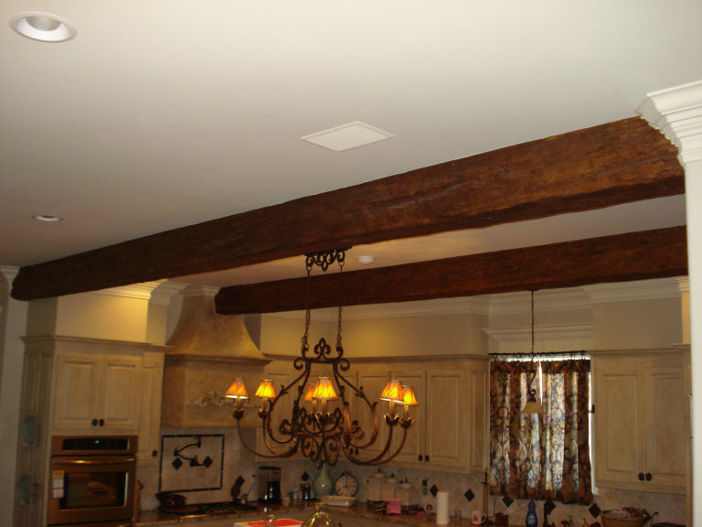 The beams are perfectly spaced; to give the illusion that they're authentic structural beams as old as Chris and Natalie's house itself.