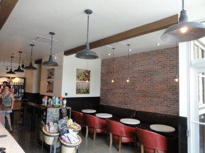 A touch of faux ceiling beams complements the brick and existing wood beautifully.