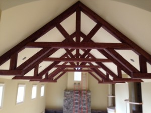 Decorative king post trusses on a home's cathedral ceiling.