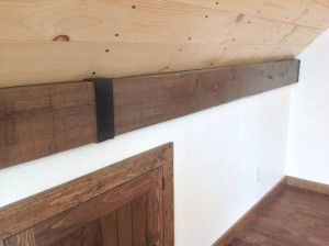 Wood planks and beams with an artificial beam strap to hide seams.