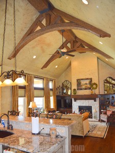 Curved trusses in a kitchen created with faux arched and straight beams.