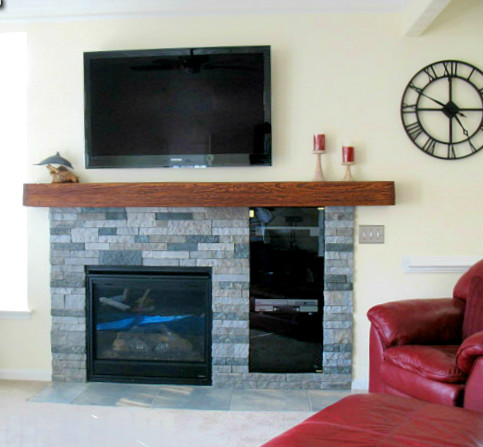 Fireplace renovation after picture: new mantel and cement aggregate panels added.