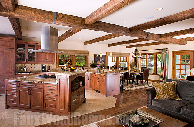Open plan kitchen, dining room, living room with polyurethane wood style beams.