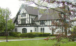 Tudor Revival home exterior remodeled with faux wood planking.