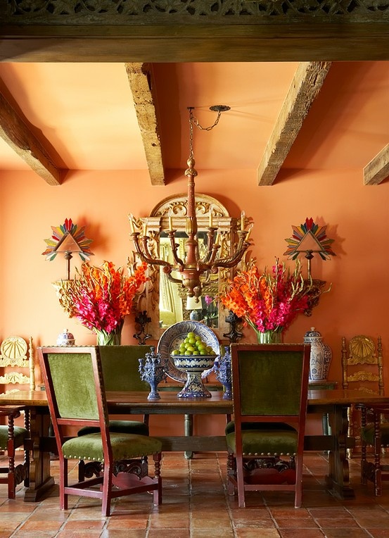 Dining room full of colorful accents anchored with wood style beams.