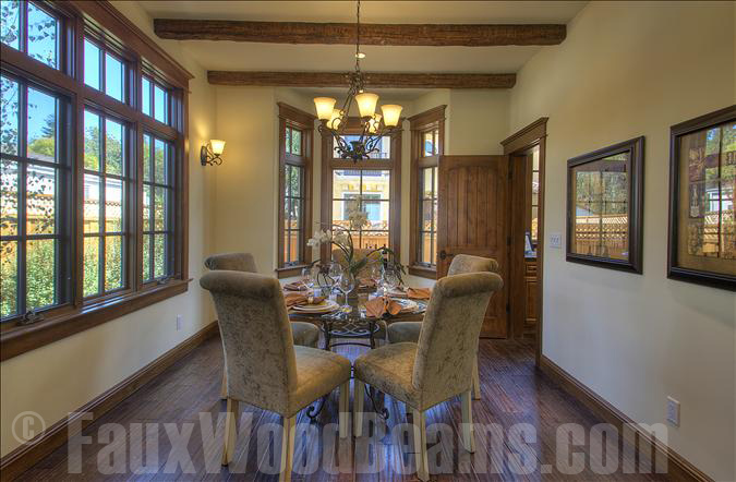 Timber beams go beautifully with this dining room's window trim