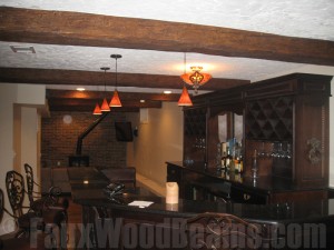 Faux beams installed on a stucco ceiling.