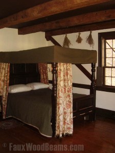 Historic home's remodeled bedroom with faux beams lending an authentic real wood look.