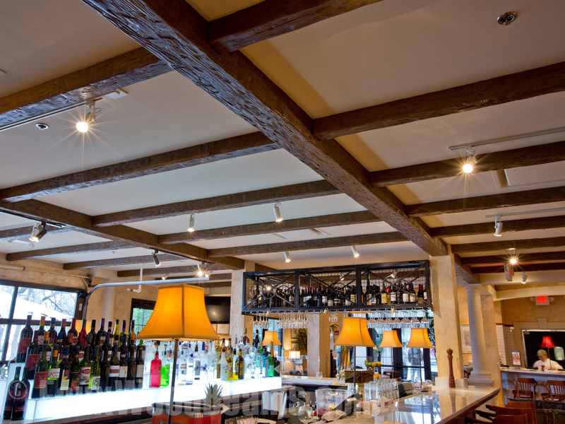 A coffered ceiling created with Tuscany beams makes interiors look beautiful.