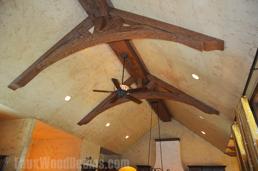 Close up view of living room trusses created with Tuscany arched and straight beams.