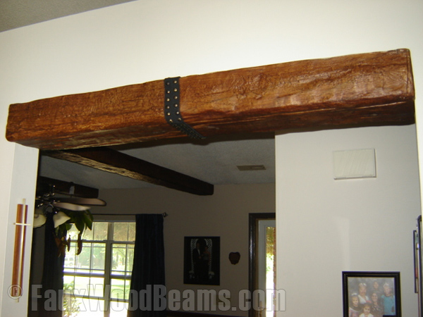 Custom Timber beam with decorative strap accents an entranceway.