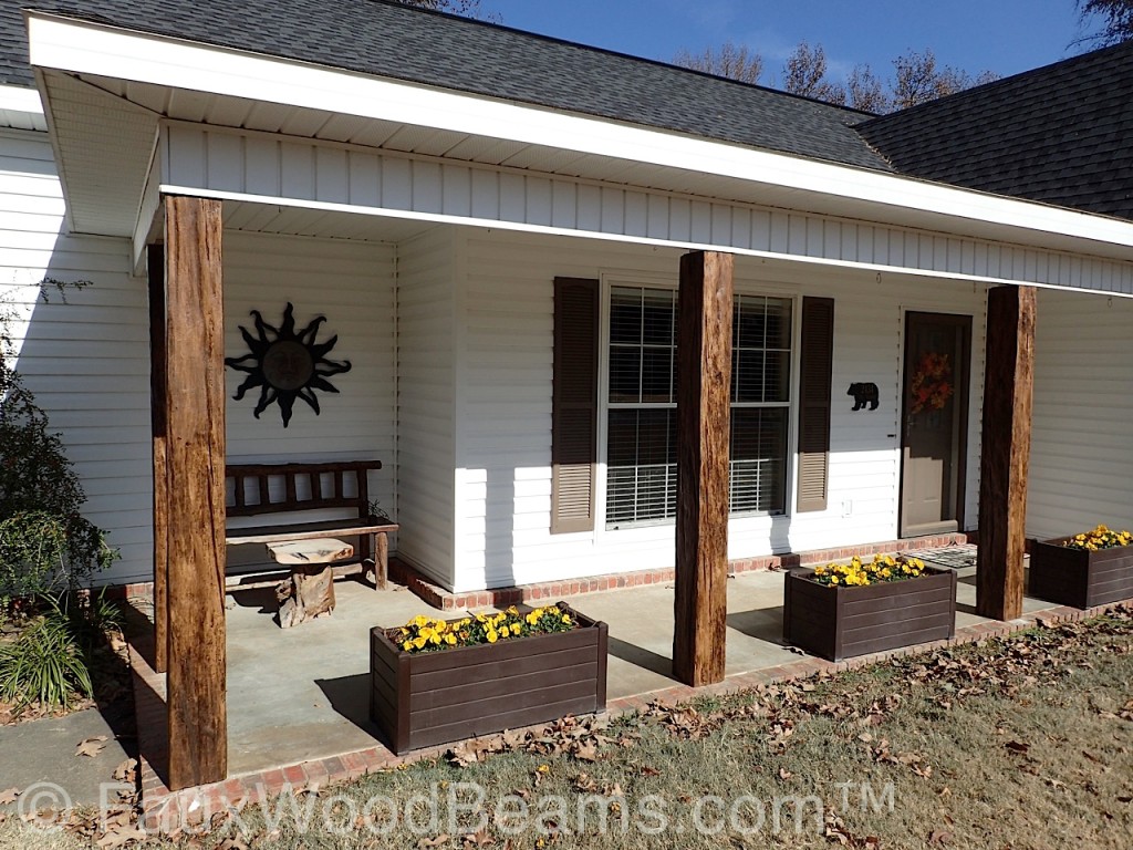 Porch posts covered with faux wood beams.