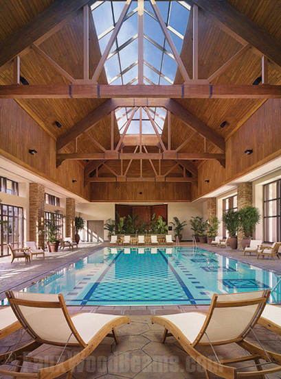 Decorative wood panels installed on the walls and ceiling above a hotel pool.