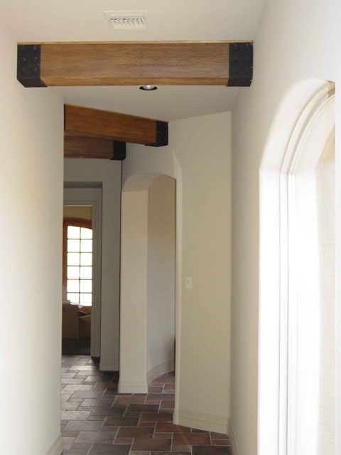 Faux iron beam straps help create the illusion of an exposed beam ceiling.