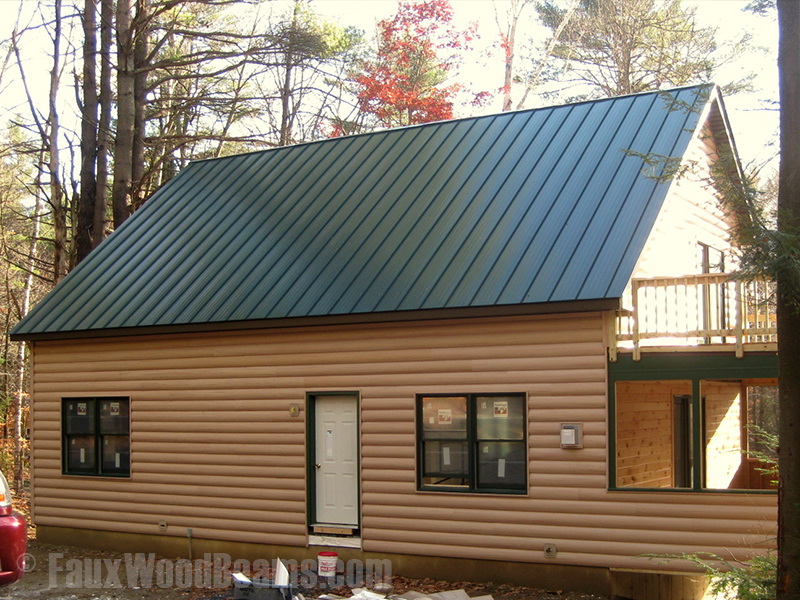 New home with log style siding in Maple color.