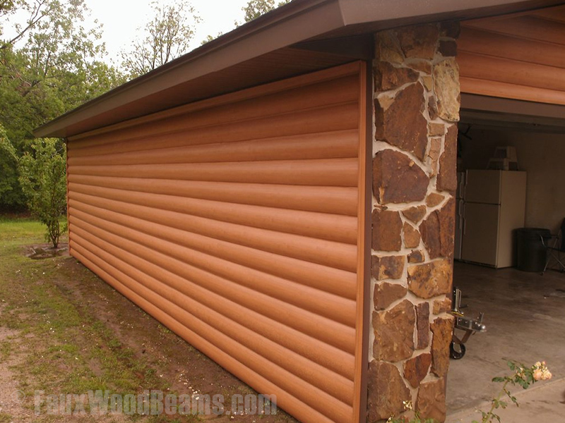 Garage with log style vinyl siding.