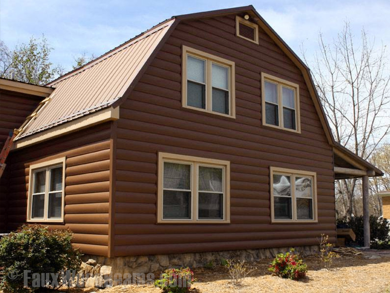 Home exterior with log style vinyl paneling.