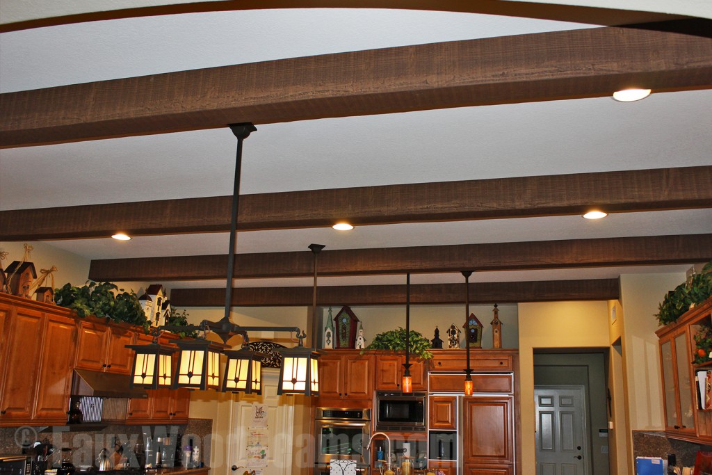 You can stain faux wood beams and create a stunning ceiling design like this one.