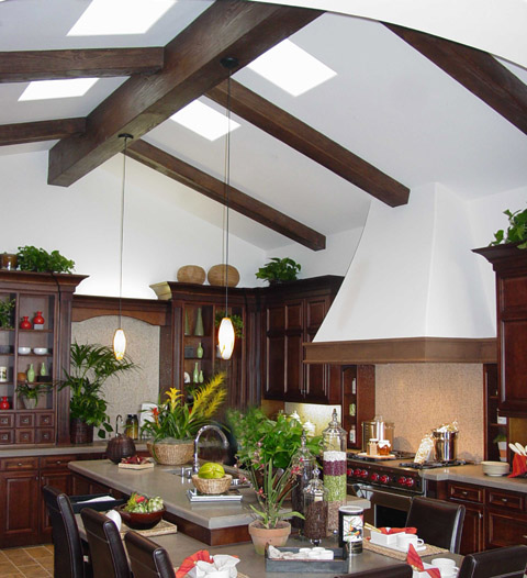 Heavy Sandblasted beams add depth to a country kitchen's vaulted ceiling