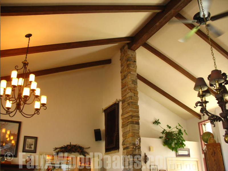 Raised Grain style beams on a living room's vaulted ceiling.