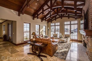 Straight and arched rough hewn beams form a truss in a formal sitting room