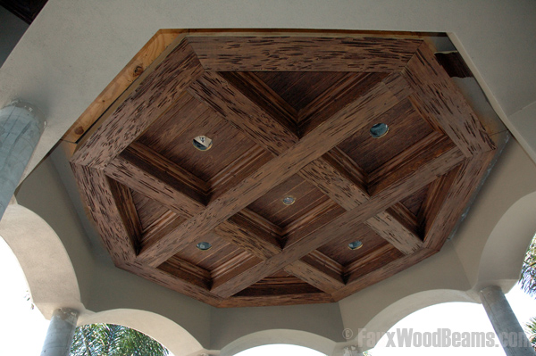 Faux pecky cypress wood beams installed on a gazebo ceiling.